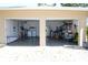 Double garage doors reveal a well-organized interior with laundry, refrigerator, and abundant storage space at 1540 Lime St, Clearwater, FL 33756