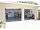 Open two-car garage with storage, laundry area, and a paver driveway at 1540 Lime St, Clearwater, FL 33756