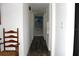 Hallway features wood floors and white walls leading to a palm tree beaded curtain at 1540 Lime St, Clearwater, FL 33756