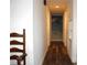 Hallway features wood floors and white walls leading to a palm tree beaded curtain at 1540 Lime St, Clearwater, FL 33756