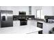 Well-lit kitchen featuring stainless steel appliances, bright countertops, and sleek fixtures at 1540 Lime St, Clearwater, FL 33756