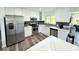 Modern kitchen with stainless steel appliances, sleek countertops, and dark backsplash at 1540 Lime St, Clearwater, FL 33756