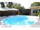 Beautiful backyard with a refreshing pool, patio area, screen porch and lush greenery at 1540 Lime St, Clearwater, FL 33756
