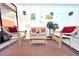 Comfortable screened porch with wicker furniture, red cushions, and a relaxing atmosphere at 1540 Lime St, Clearwater, FL 33756