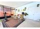 Cozy screened-in porch with wicker furniture, plants, and view of the outdoor surroundings at 1540 Lime St, Clearwater, FL 33756