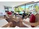 Relaxing screened porch with wicker furniture, view of the pool, and outdoor exercise equipment at 1540 Lime St, Clearwater, FL 33756