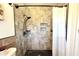 Tiled shower with modern fixtures, convenient shelves, and a neutral color palette at 1540 Lime St, Clearwater, FL 33756