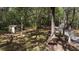 Backyard featuring a storage shed, mature trees, and a bench at 18255 Lake Lindsey Rd, Brooksville, FL 34601