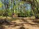Backyard featuring a storage shed, mature trees, and a bike rack at 18255 Lake Lindsey Rd, Brooksville, FL 34601