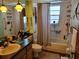 Bathroom with a sink, toilet, bathtub, and mirrored wall at 18255 Lake Lindsey Rd, Brooksville, FL 34601