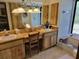 Bathroom with double sinks, wooden cabinetry, and a bathtub at 18255 Lake Lindsey Rd, Brooksville, FL 34601