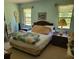 Bedroom featuring two windows, a bed, and two nightstands at 18255 Lake Lindsey Rd, Brooksville, FL 34601
