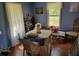 Bright dining room with hardwood floors, a blue color scheme, and natural light at 18255 Lake Lindsey Rd, Brooksville, FL 34601