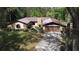 Charming single-story home with a metal roof, stone accents, and a well-maintained front yard at 18255 Lake Lindsey Rd, Brooksville, FL 34601
