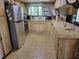Functional kitchen with wood cabinets, stainless steel appliances, and a view of the outdoors at 18255 Lake Lindsey Rd, Brooksville, FL 34601