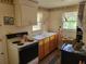 Cozy kitchen featuring vintage appliances, wood cabinets, and bright natural light at 18255 Lake Lindsey Rd, Brooksville, FL 34601