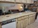 Cozy kitchen with an eat-in counter, ample cabinet space, and an open view to the living area at 18255 Lake Lindsey Rd, Brooksville, FL 34601