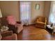 Cozy living room with vintage furniture, hardwood floors, and soft, natural light through the windows at 18255 Lake Lindsey Rd, Brooksville, FL 34601