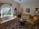 Bright and airy living room with patterned sofas, a round wood table, and decorative artwork at 18255 Lake Lindsey Rd, Brooksville, FL 34601