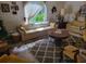 Spacious living room with a large area rug, comfortable seating, and a view of the outdoors at 18255 Lake Lindsey Rd, Brooksville, FL 34601