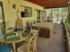 Covered patio with outdoor furniture and hot tub, perfect for relaxation at 18255 Lake Lindsey Rd, Brooksville, FL 34601