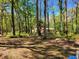Picturesque property view with a glimpse of a house nestled in the trees at 18255 Lake Lindsey Rd, Brooksville, FL 34601