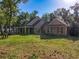 Expansive backyard featuring lush lawn and mature trees, providing a serene and private outdoor space at 18308 Valor Path, Brooksville, FL 34604