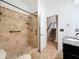 Accessible bathroom featuring a walk-in shower with tile surround and grab bars at 18308 Valor Path, Brooksville, FL 34604