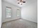 Bright bedroom with two windows for natural light and neutral carpet at 18308 Valor Path, Brooksville, FL 34604
