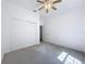 Bedroom with carpet floors, window, ceiling fan and closet at 18308 Valor Path, Brooksville, FL 34604