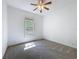 Bedroom with carpet floors, window, and ceiling fan at 18308 Valor Path, Brooksville, FL 34604