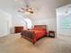 Large bedroom with ceiling fan, desk and a view of the windows at 18308 Valor Path, Brooksville, FL 34604