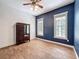 Stylish bedroom with wood-look tile flooring, modern dark blue wall, and two windows for natural light at 18308 Valor Path, Brooksville, FL 34604