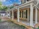 Exterior view of the house with a long front porch and white pillars at 18308 Valor Path, Brooksville, FL 34604
