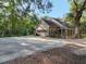 A view of the house from the side yard with a shed and a garage at 18308 Valor Path, Brooksville, FL 34604
