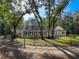 View of home showcasing the large front porch, dormer windows, and a red front door at 18308 Valor Path, Brooksville, FL 34604