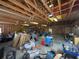 Large garage interior with exposed wooden beams, storage shelves, and ample workspace at 18308 Valor Path, Brooksville, FL 34604