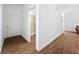 Hallway that leads to a bath with tiled floors and white walls at 18308 Valor Path, Brooksville, FL 34604