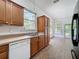 Eat in kitchen boasts oak cabinets, double basin sink, and tile flooring at 18308 Valor Path, Brooksville, FL 34604