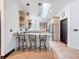 Bright kitchen with an island and seating, granite countertops, skylight, and modern appliances at 18308 Valor Path, Brooksville, FL 34604