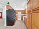 Kitchen features oak cabinets, white appliances, and tile floors at 18308 Valor Path, Brooksville, FL 34604