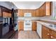 Kitchen with white appliances, oak cabinets, and hard surface counters at 18308 Valor Path, Brooksville, FL 34604