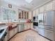 Updated kitchen features stainless steel appliances, a copper sink, and ample counter space at 18308 Valor Path, Brooksville, FL 34604