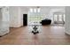 Bright living room with skylights, high ceilings, and large glass doors for natural light and outdoor access at 18308 Valor Path, Brooksville, FL 34604
