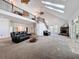 Bright living room featuring a fireplace, upper level loft, and plush seating arrangements at 18308 Valor Path, Brooksville, FL 34604