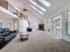 Spacious living room with skylights, fireplace, and staircase leading to an upper level at 18308 Valor Path, Brooksville, FL 34604
