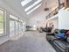 Bright living room with soaring ceilings, skylights, and an open connection to the outdoor space at 18308 Valor Path, Brooksville, FL 34604