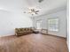 Bright living room featuring wood-look tile floors and large windows at 18308 Valor Path, Brooksville, FL 34604