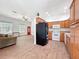 Open-concept floor plan with wood-look tile flooring connecting living room to kitchen at 18308 Valor Path, Brooksville, FL 34604