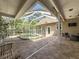 Relaxing screened pool with outdoor seating and mature trees at 18308 Valor Path, Brooksville, FL 34604